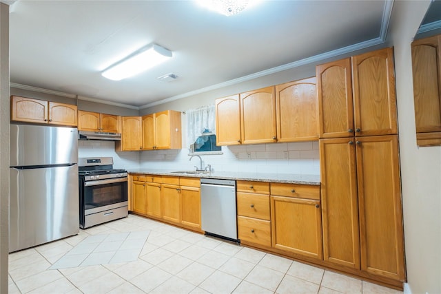 kitchen with stainless steel appliances, ornamental molding, a sink, light stone countertops, and under cabinet range hood