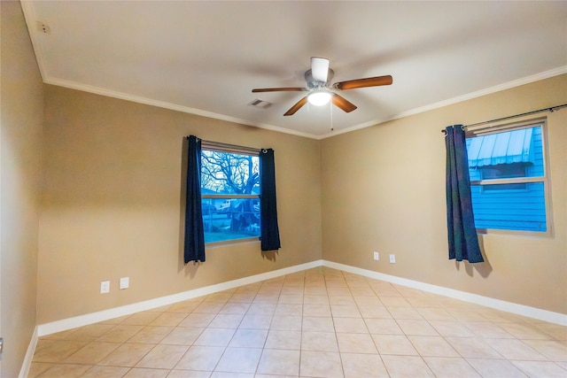 spare room with light tile patterned floors, visible vents, ornamental molding, ceiling fan, and baseboards