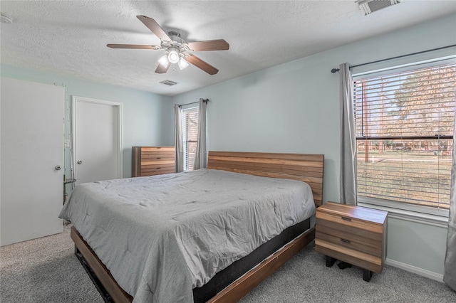 2 Brown Rd, Huntsville, TX 77320 - carpeted bedroom featuring a ceiling fan, visible vents, a textured ceiling, and baseboards