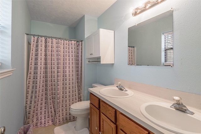 2 Brown Rd, Huntsville, TX 77320 - full bath featuring a textured ceiling, double vanity, a sink, and toilet