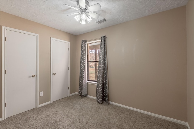 2 Brown Rd, Huntsville, TX 77320 - unfurnished bedroom featuring a textured ceiling, carpet floors, visible vents, and baseboards