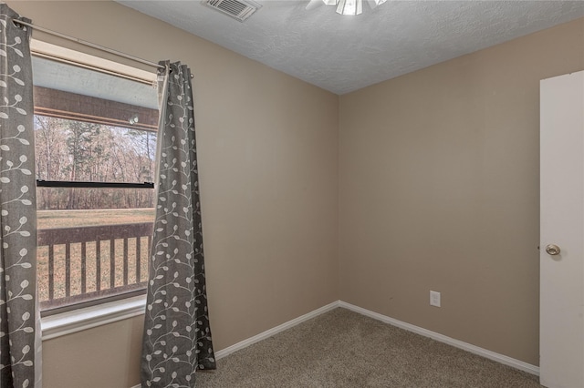 2 Brown Rd, Huntsville, TX 77320 - empty room featuring a textured ceiling, carpet flooring, visible vents, and baseboards