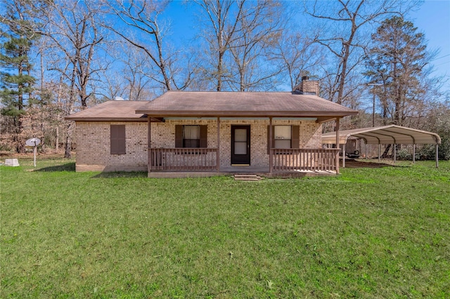 2 Brown Rd, Huntsville, TX 77320 - view of front of house with brick siding, a chimney, a porch, a front yard, and a carport