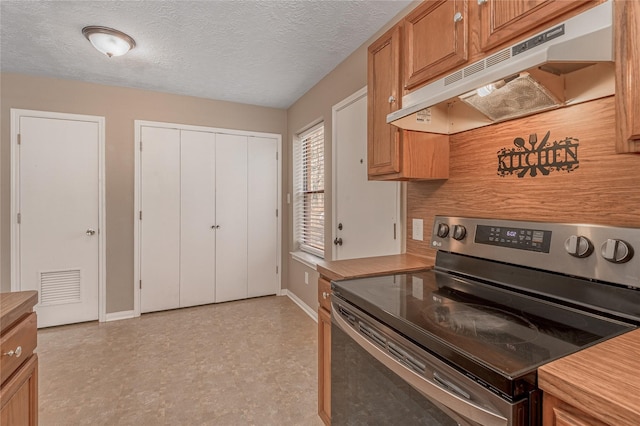 2 Brown Rd, Huntsville, TX 77320 - kitchen featuring brown cabinets, under cabinet range hood, light countertops, and electric range