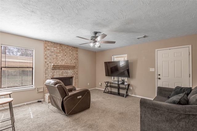 2 Brown Rd, Huntsville, TX 77320 - living room featuring carpet floors, a fireplace, visible vents, ceiling fan, and baseboards