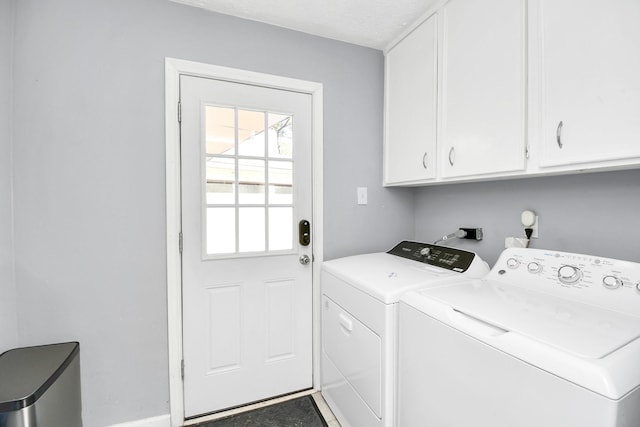 laundry room with cabinet space and washing machine and dryer