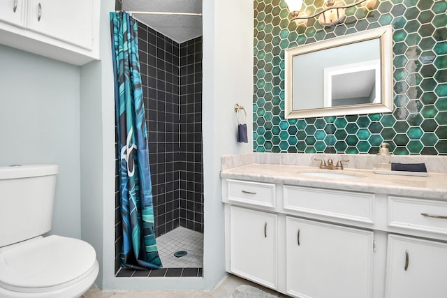 full bathroom featuring toilet, a stall shower, and vanity