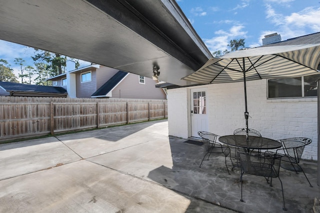 view of patio / terrace featuring outdoor dining area and fence