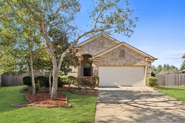 ranch-style house with a front yard, fence, and brick siding