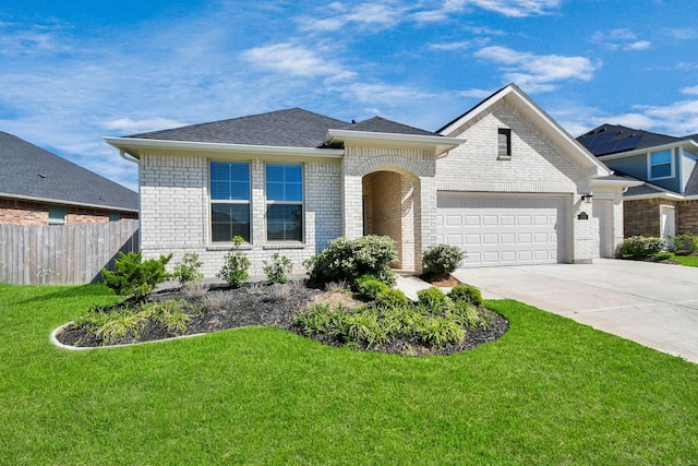 view of front of home featuring driveway, a garage, fence, a front lawn, and brick siding