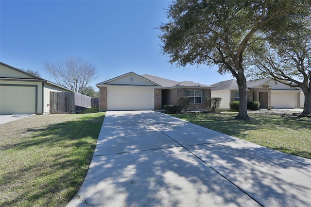 ranch-style home featuring an attached garage, brick siding, fence, concrete driveway, and a front yard