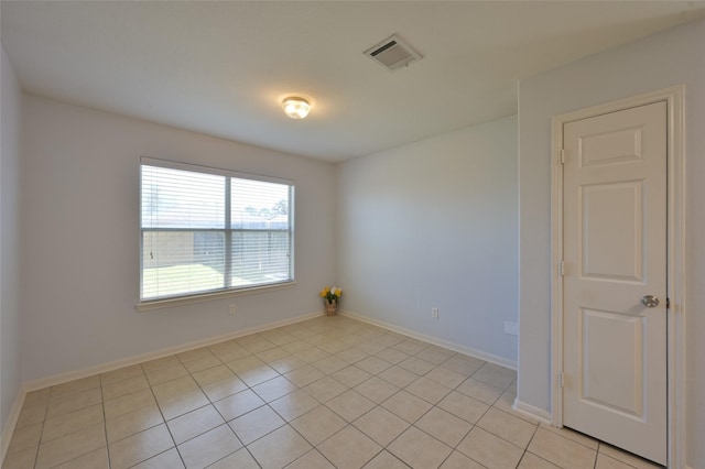 unfurnished room with light tile patterned floors, visible vents, and baseboards