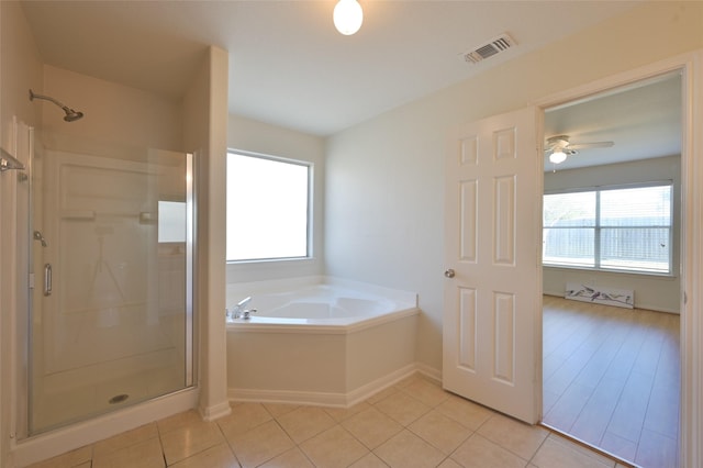 bathroom featuring tile patterned floors, visible vents, a shower stall, and a bath