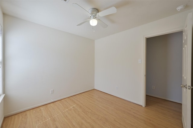 unfurnished room featuring light wood-style floors, ceiling fan, and baseboards