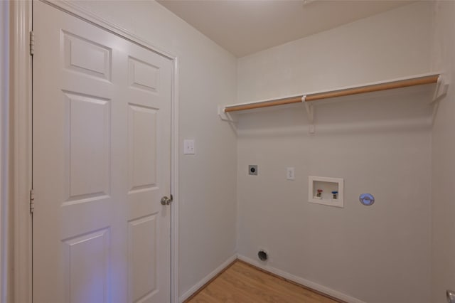 clothes washing area with laundry area, baseboards, light wood-style flooring, washer hookup, and electric dryer hookup