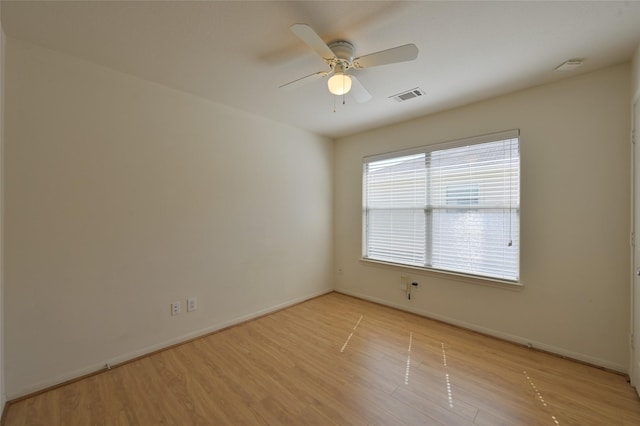 unfurnished room with light wood-style floors, visible vents, ceiling fan, and baseboards