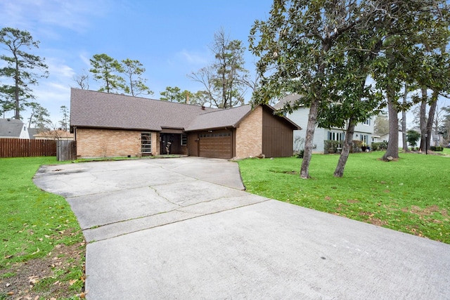 view of front of house featuring a garage, a front yard, brick siding, and fence