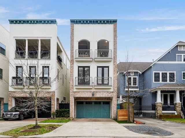 townhome / multi-family property with a garage, driveway, french doors, and fence