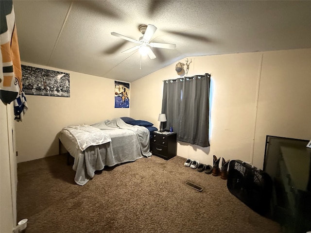 bedroom featuring visible vents, a ceiling fan, lofted ceiling, a textured ceiling, and carpet floors