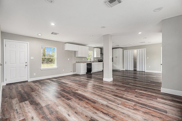 unfurnished living room with recessed lighting, dark wood-style flooring, visible vents, and baseboards