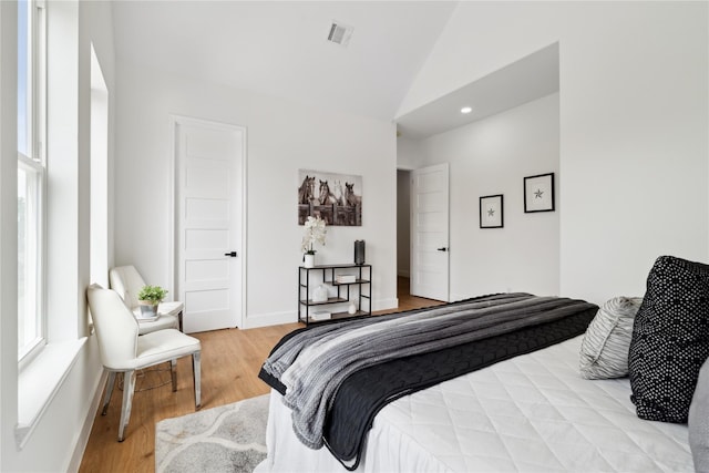 bedroom featuring baseboards, visible vents, vaulted ceiling, light wood-type flooring, and recessed lighting