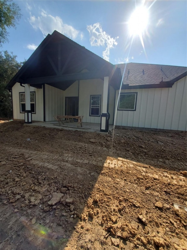 rear view of property with board and batten siding