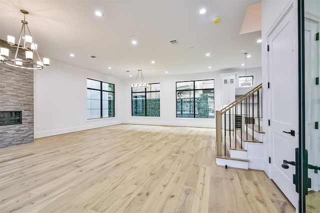 living room with recessed lighting, a fireplace, visible vents, stairway, and light wood finished floors