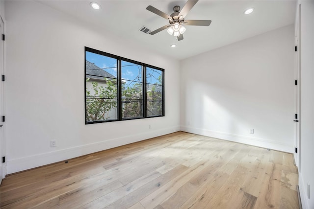 spare room with recessed lighting, visible vents, light wood-style flooring, and baseboards