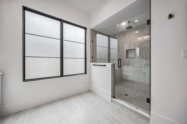 full bath featuring a stall shower and baseboards