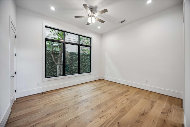 spare room featuring baseboards, recessed lighting, visible vents, and light wood-style floors