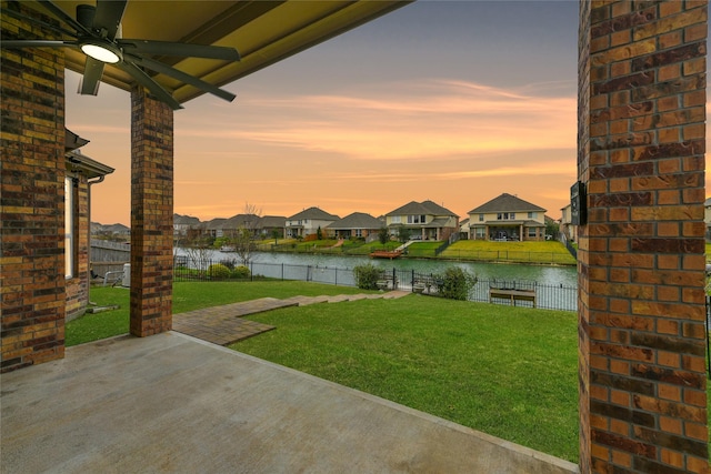 24030 Tirso River Ct, Katy, TX 77493 - view of yard featuring a fenced backyard, ceiling fan, a patio area, and a water view