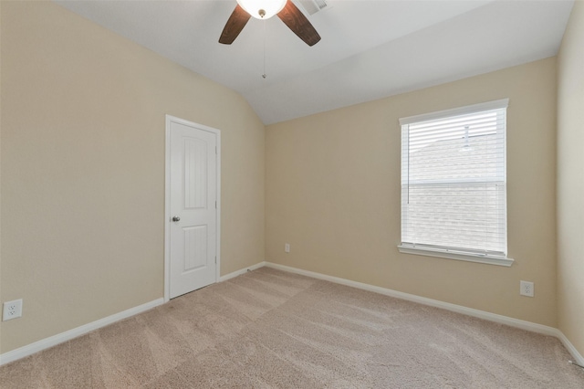 empty room with light carpet, visible vents, baseboards, and lofted ceiling