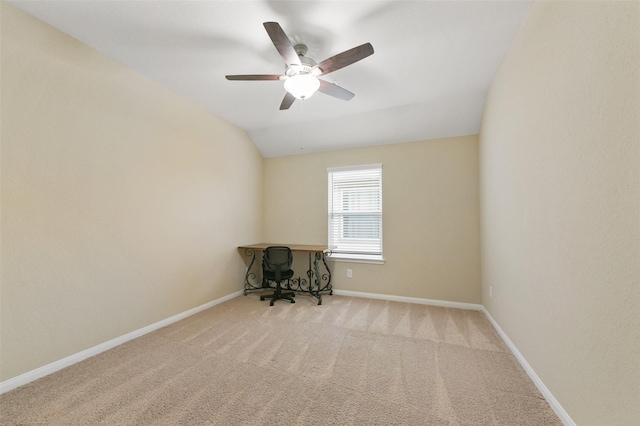 unfurnished room featuring carpet floors, baseboards, vaulted ceiling, and a ceiling fan