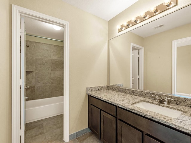 full bath with tile patterned flooring, vanity, visible vents, baseboards, and tub / shower combination