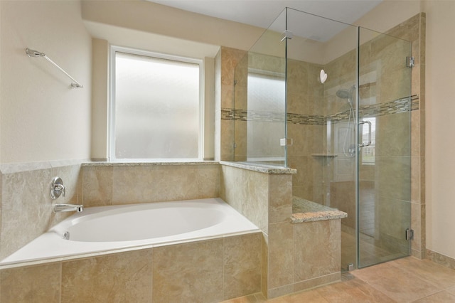 bathroom with a shower stall and a bath