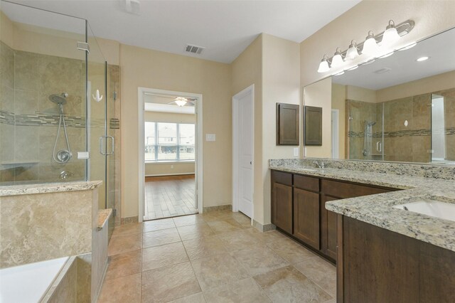 bathroom with double vanity, a stall shower, a sink, and visible vents