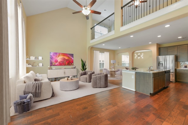 living room featuring high vaulted ceiling, recessed lighting, dark wood-type flooring, visible vents, and a ceiling fan