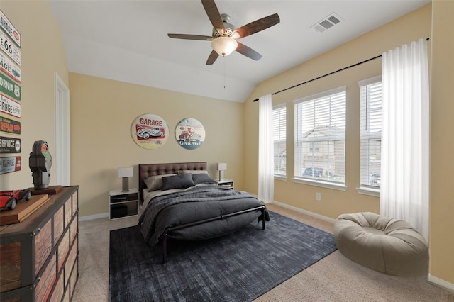 carpeted bedroom with lofted ceiling, baseboards, visible vents, and ceiling fan