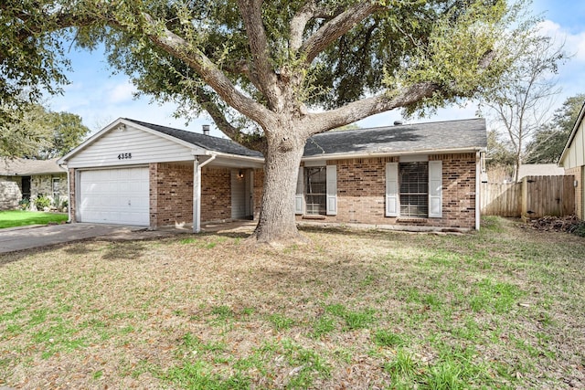 ranch-style house featuring a garage, fence, a front lawn, and brick siding