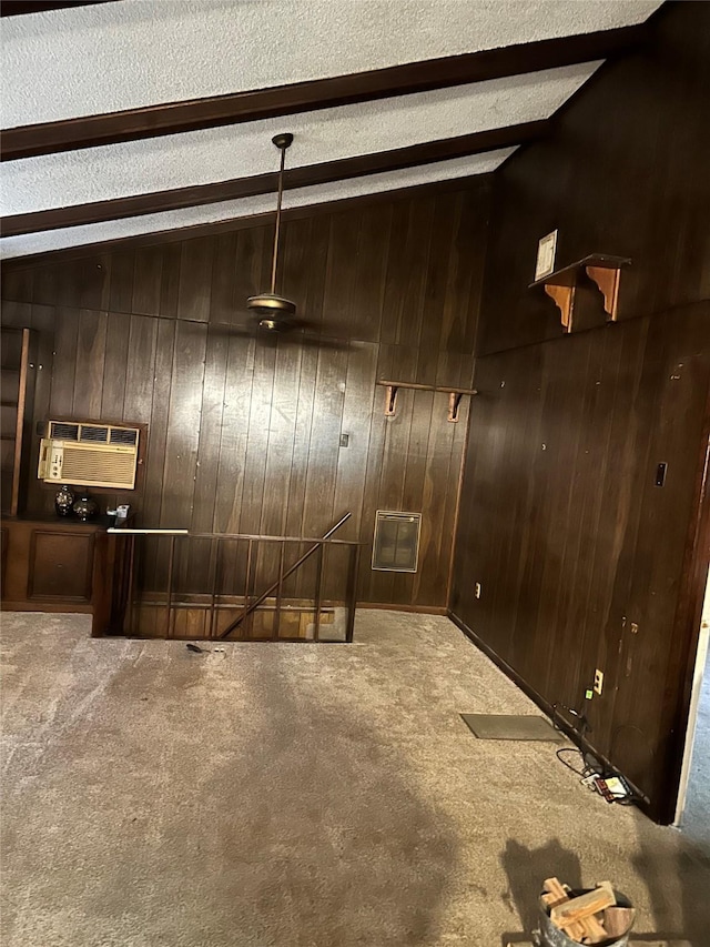 interior space with light carpet, wood walls, a textured ceiling, and a wall mounted air conditioner