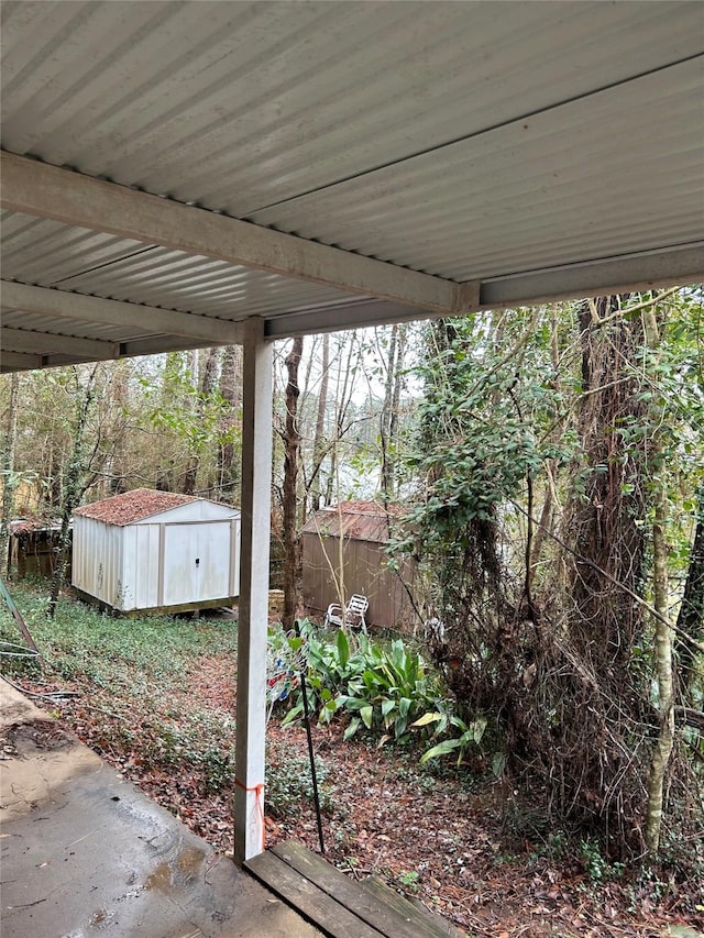 view of yard featuring a storage shed, an outbuilding, and fence