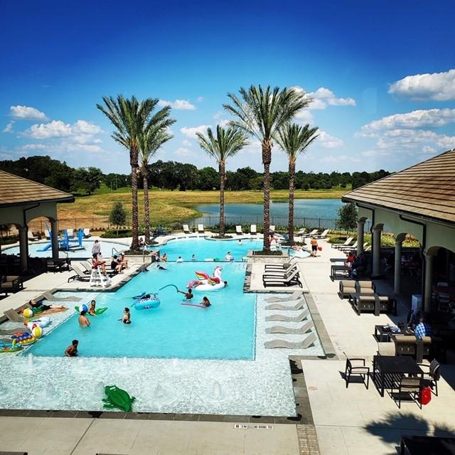 pool featuring a patio area and a water view