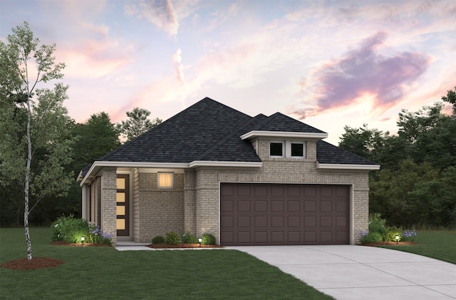 french provincial home featuring a garage, concrete driveway, a shingled roof, and a lawn