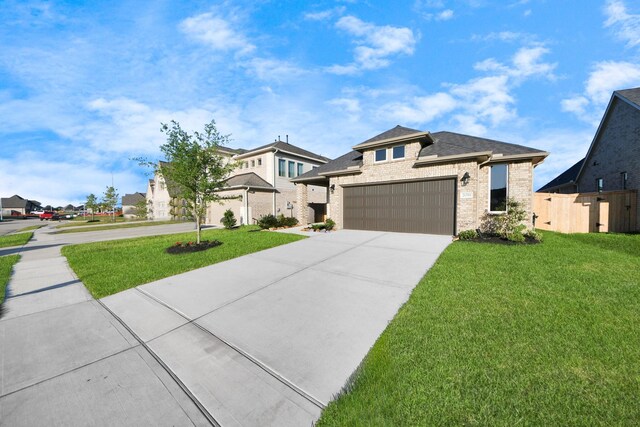 21311 Bridle Rose Trl, Tomball, TX 77377 - view of front of property featuring a front lawn, fence, a garage, and concrete driveway