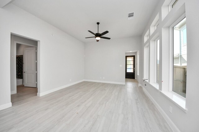 21311 Bridle Rose Trl, Tomball, TX 77377 - unfurnished room featuring light wood finished floors, visible vents, baseboards, and a ceiling fan