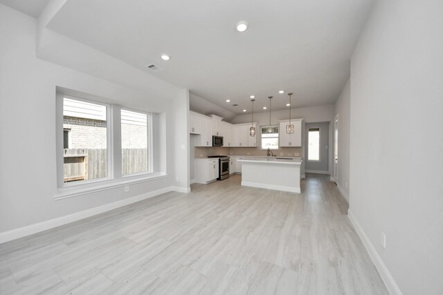 21311 Bridle Rose Trl, Tomball, TX 77377 - unfurnished living room featuring recessed lighting, visible vents, and baseboards