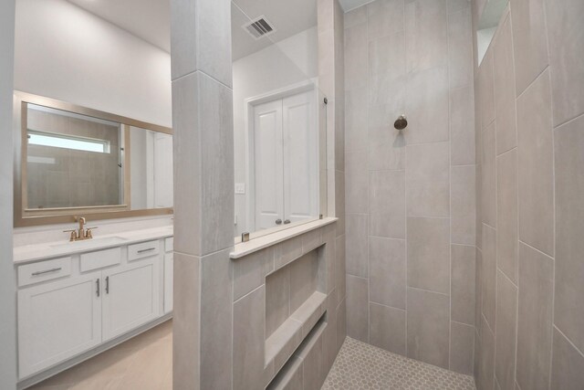 21311 Bridle Rose Trl, Tomball, TX 77377 - full bathroom with a tile shower, vanity, and visible vents