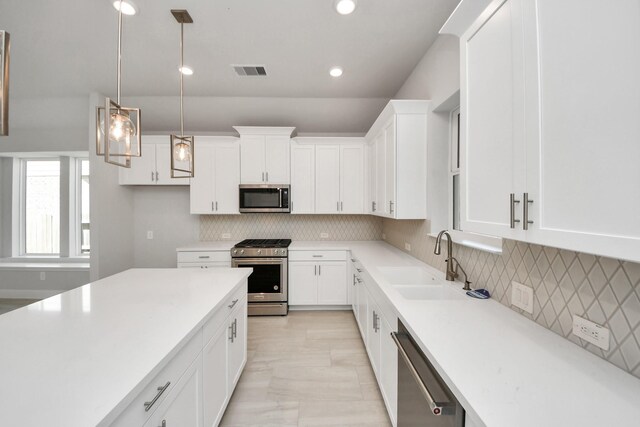 21311 Bridle Rose Trl, Tomball, TX 77377 - kitchen featuring white cabinets, visible vents, light countertops, a sink, and stainless steel appliances