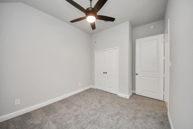 21311 Bridle Rose Trl, Tomball, TX 77377 - unfurnished bedroom featuring carpet floors, baseboards, a closet, and vaulted ceiling