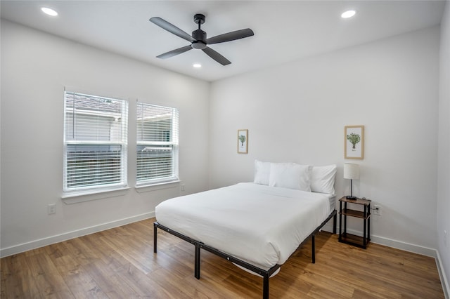 bedroom with ceiling fan, recessed lighting, wood finished floors, and baseboards